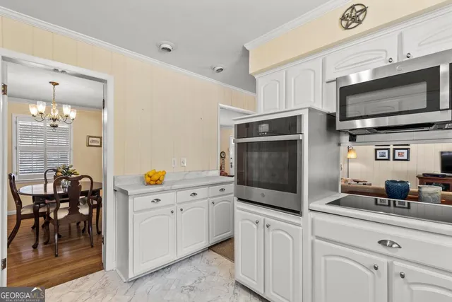 a kitchen with stainless steel appliances a stove microwave and cabinets