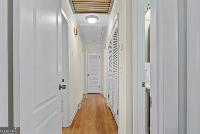 a view of a hallway with wooden floor