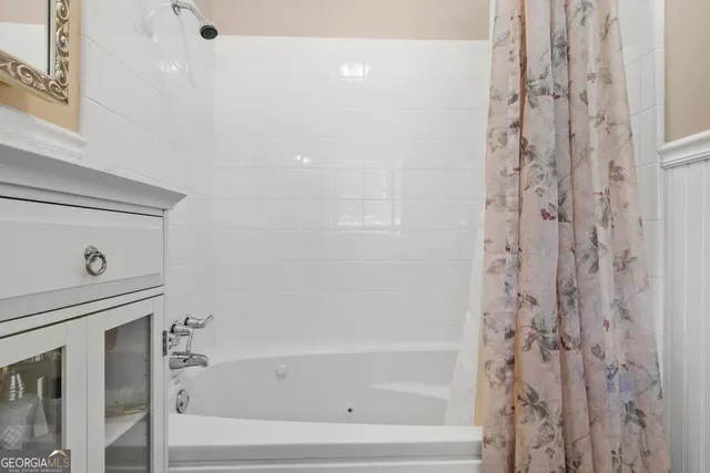 a bathroom with bathtub and shower