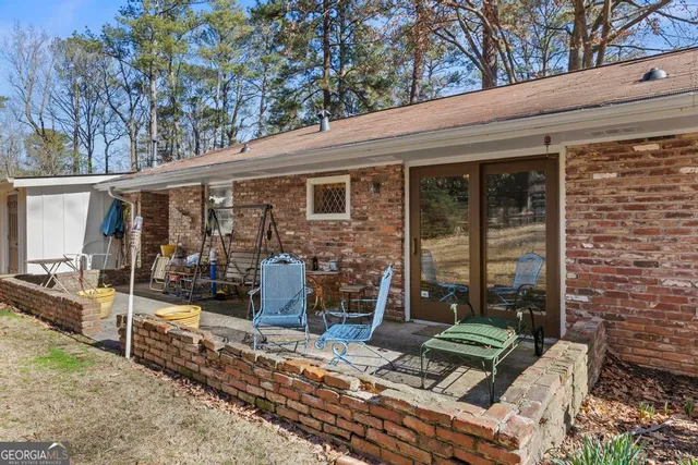 a view of a patio with couches chairs and potted plants