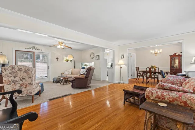 a living room with furniture and wooden floor