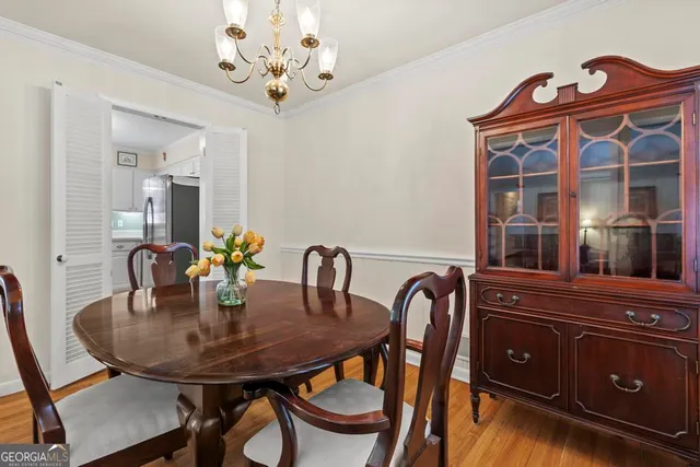 a view of a dining room with furniture and chandelier