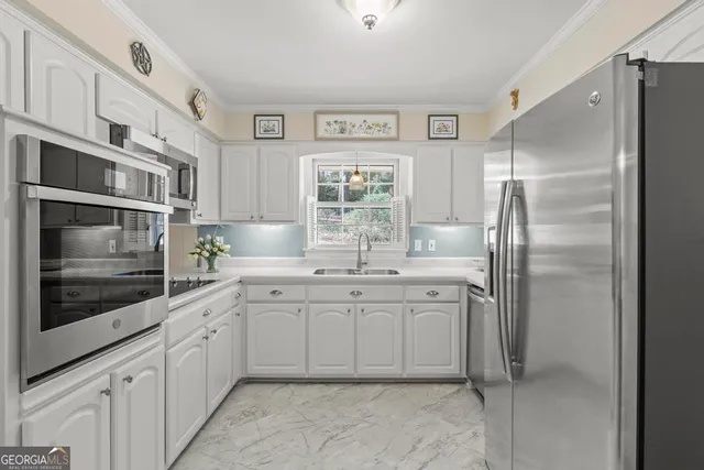 a kitchen with stainless steel appliances granite countertop a refrigerator and a sink