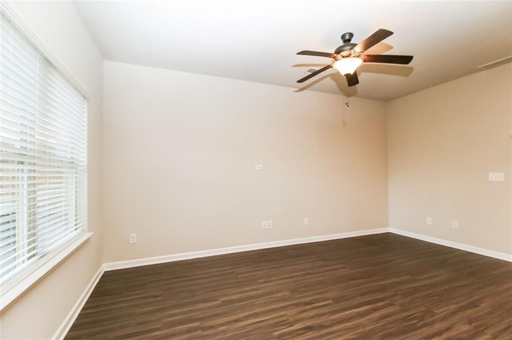 195 Skipjack Court Covington, GA 30016 - Photo 3 of 15 wooden floor in an empty room with a window