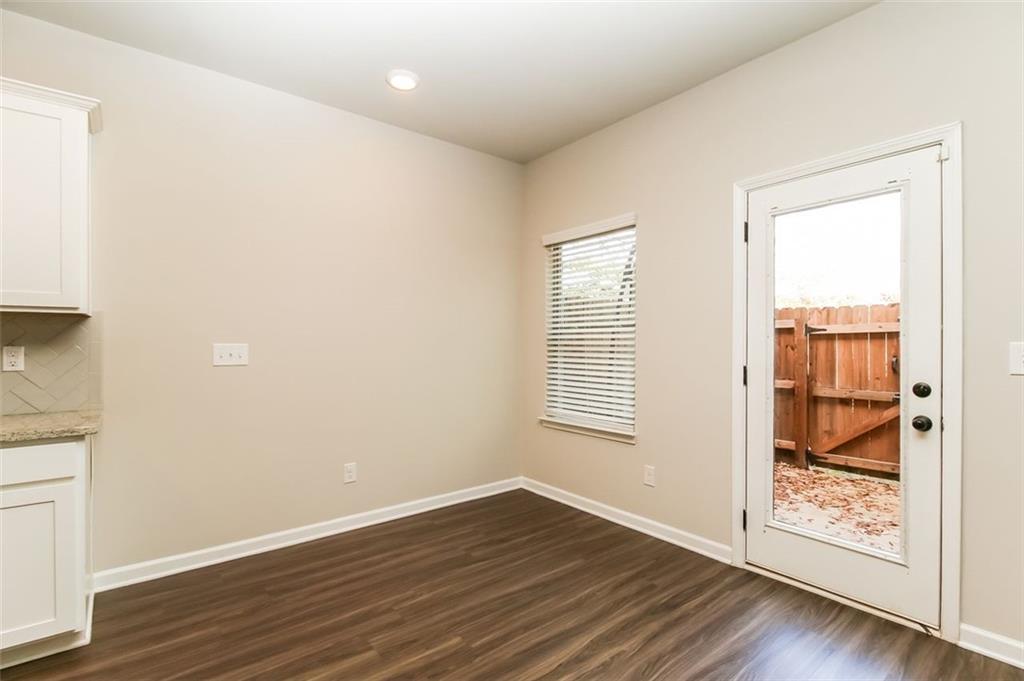 195 Skipjack Court Covington, GA 30016 - Photo 5 of 15 an empty room with wooden floor and windows