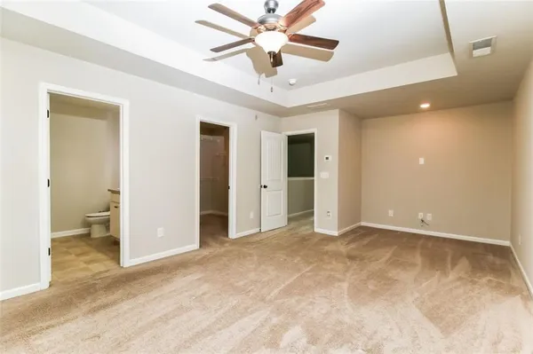 a view of a livingroom with a chandelier fan and a bathroom