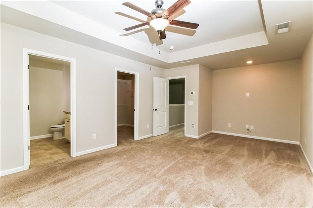 195 Skipjack Court Covington, GA 30016 - Photo 9 of 15 a view of a livingroom with a chandelier fan and a bathroom
