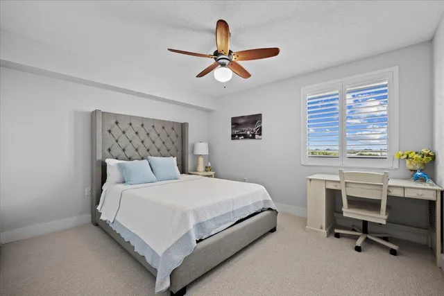 a bedroom with a bed chair and a window