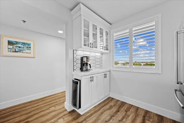 a view of a kitchen with wooden floor and a window