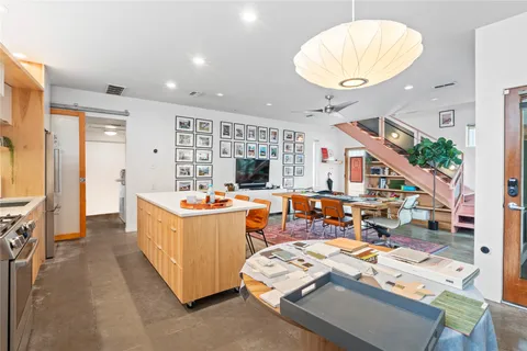 a living room with a table and chairs