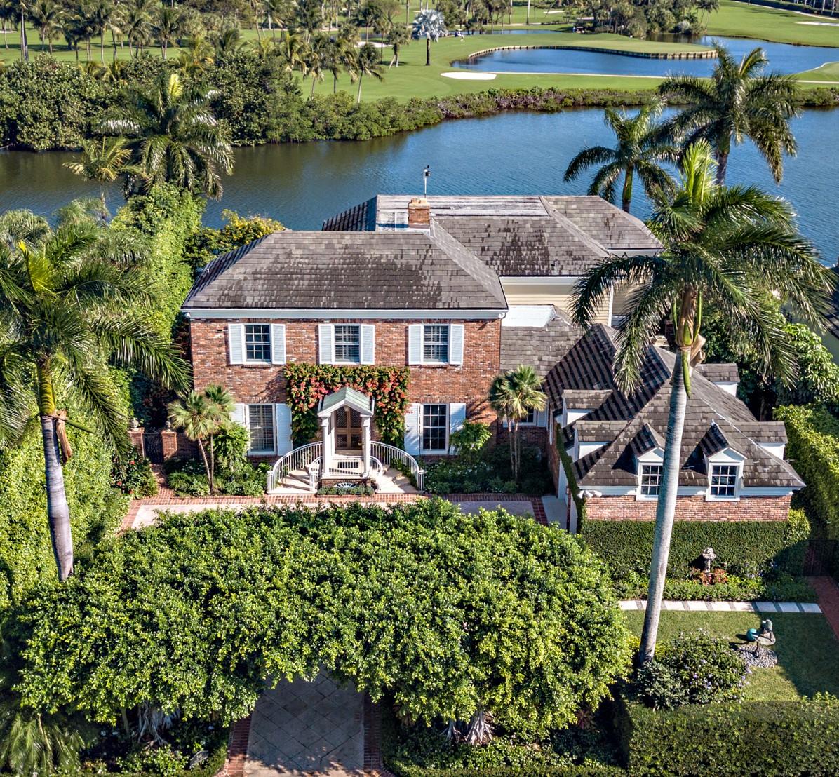 an aerial view of a house with garden space and a patio