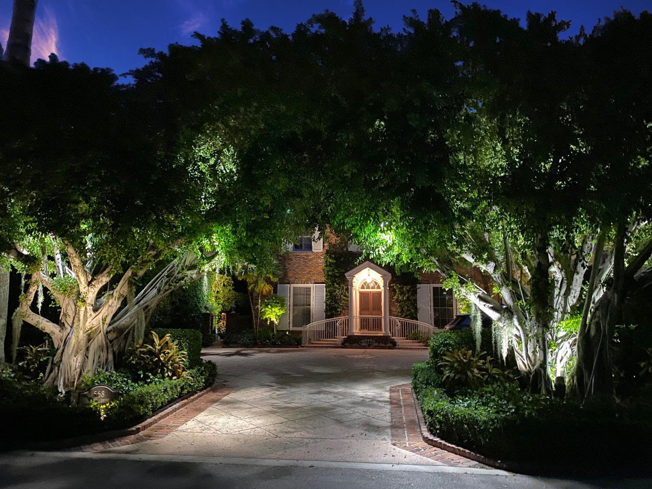 568 Island Drive Palm Beach, FL 33480 - Photo 2 of 34 a front view of a house with a yard