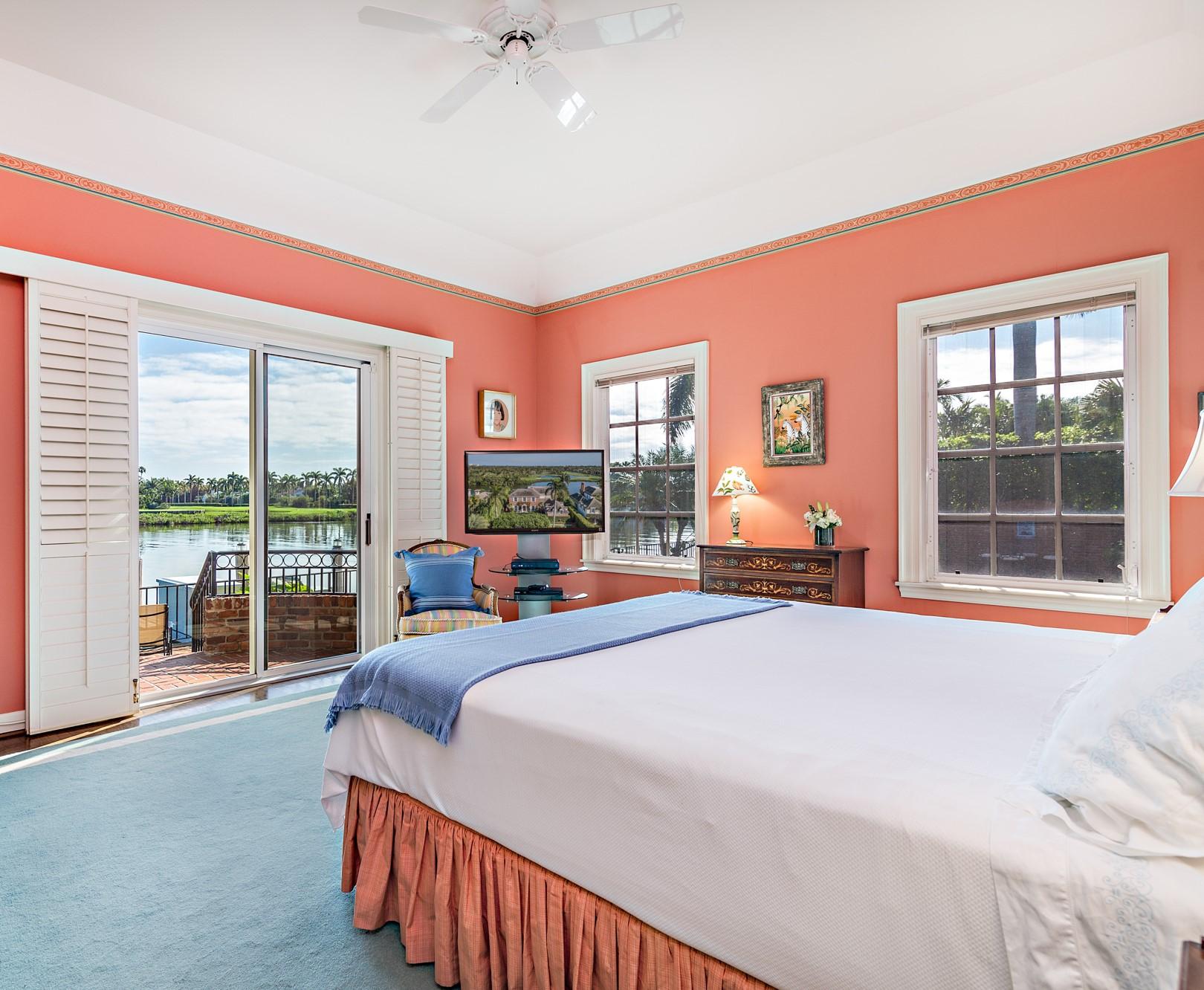 568 Island Drive Palm Beach, FL 33480 - Photo 17 of 34 a bedroom with a bed and a large window