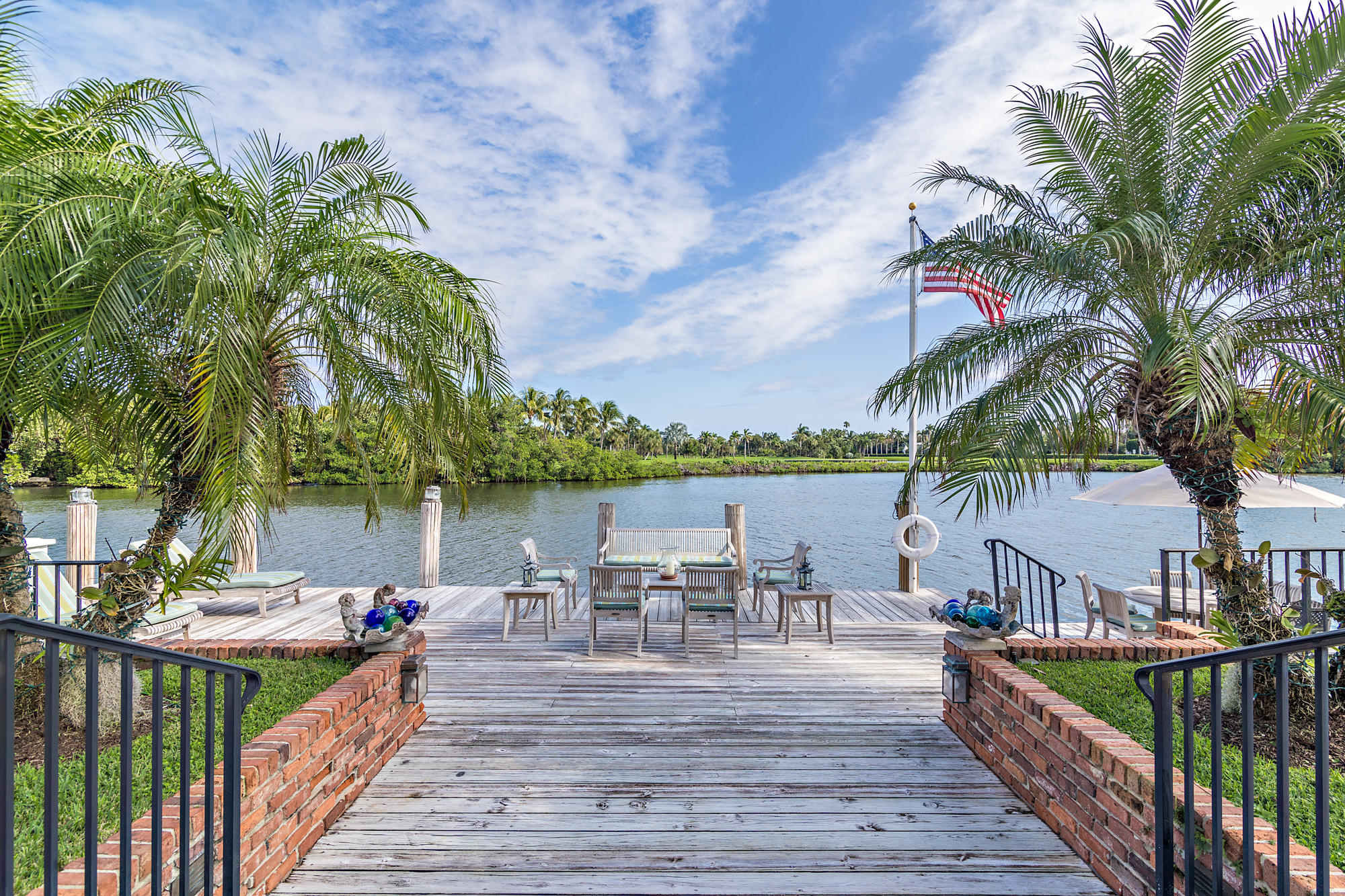 568 Island Drive Palm Beach, FL 33480 - Photo 27 of 34 a view of a lake with a table and chairs