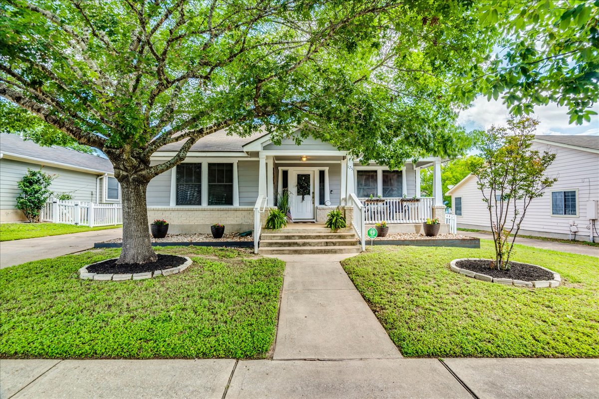 175 Wetzel Kyle, TX 78640 - Photo 6 of 27 A welcoming front porch leads to this charming residence framed by mature trees and manicured landscaping.
