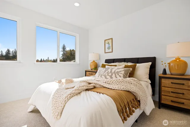 a bedroom with a bed and a painting on the wall