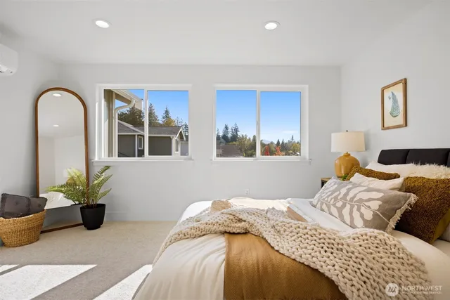 a bedroom with a bed and a potted plant