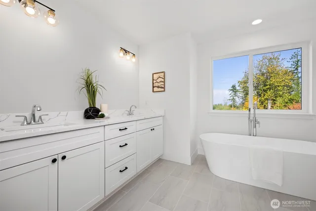 a bathroom with a bathtub sink and mirror