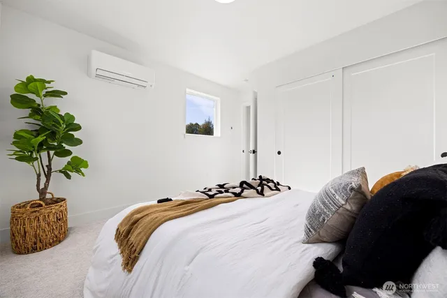 a bedroom with bed and a potted plant