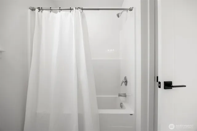 a bathroom with a shower and a tub
