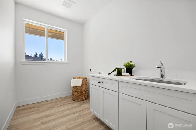 a view of cabinets with wooden floor and sink