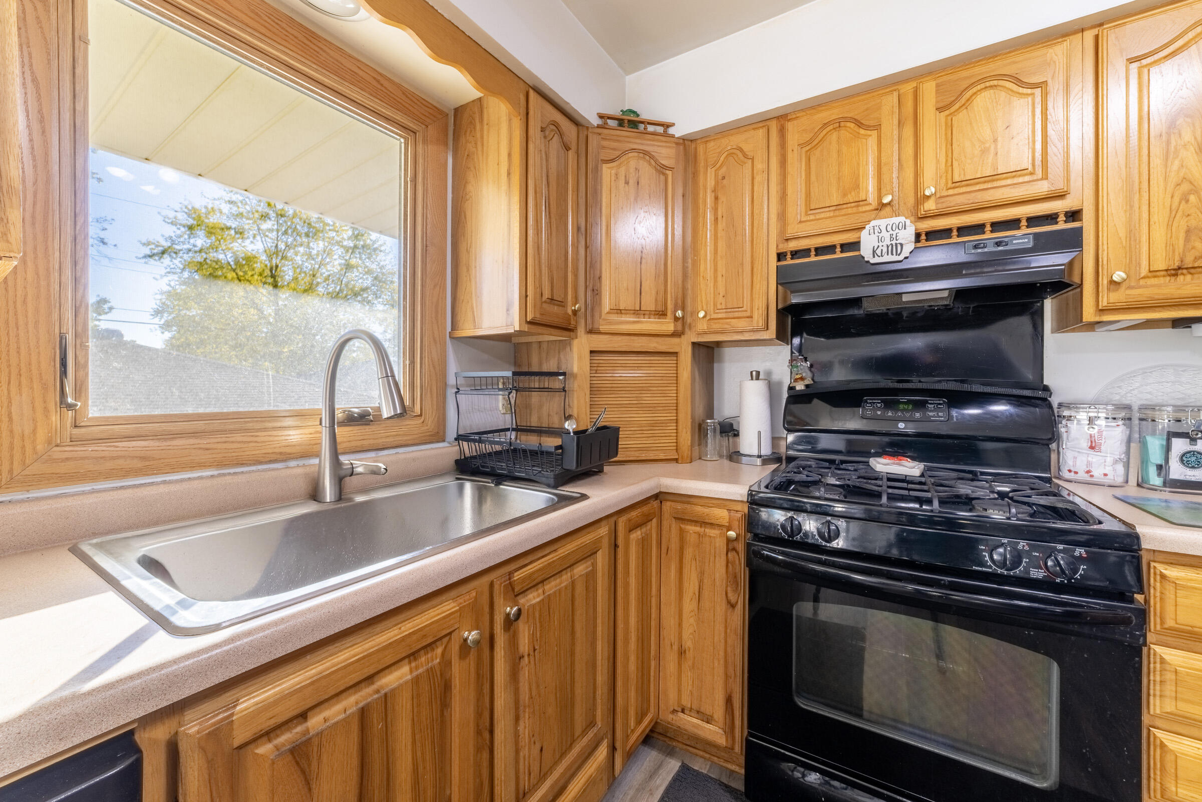 225 North Dwiggins Street Griffith, IN 46319 - Photo 14 of 36 a kitchen with stainless steel appliances a stove sink and cabinets