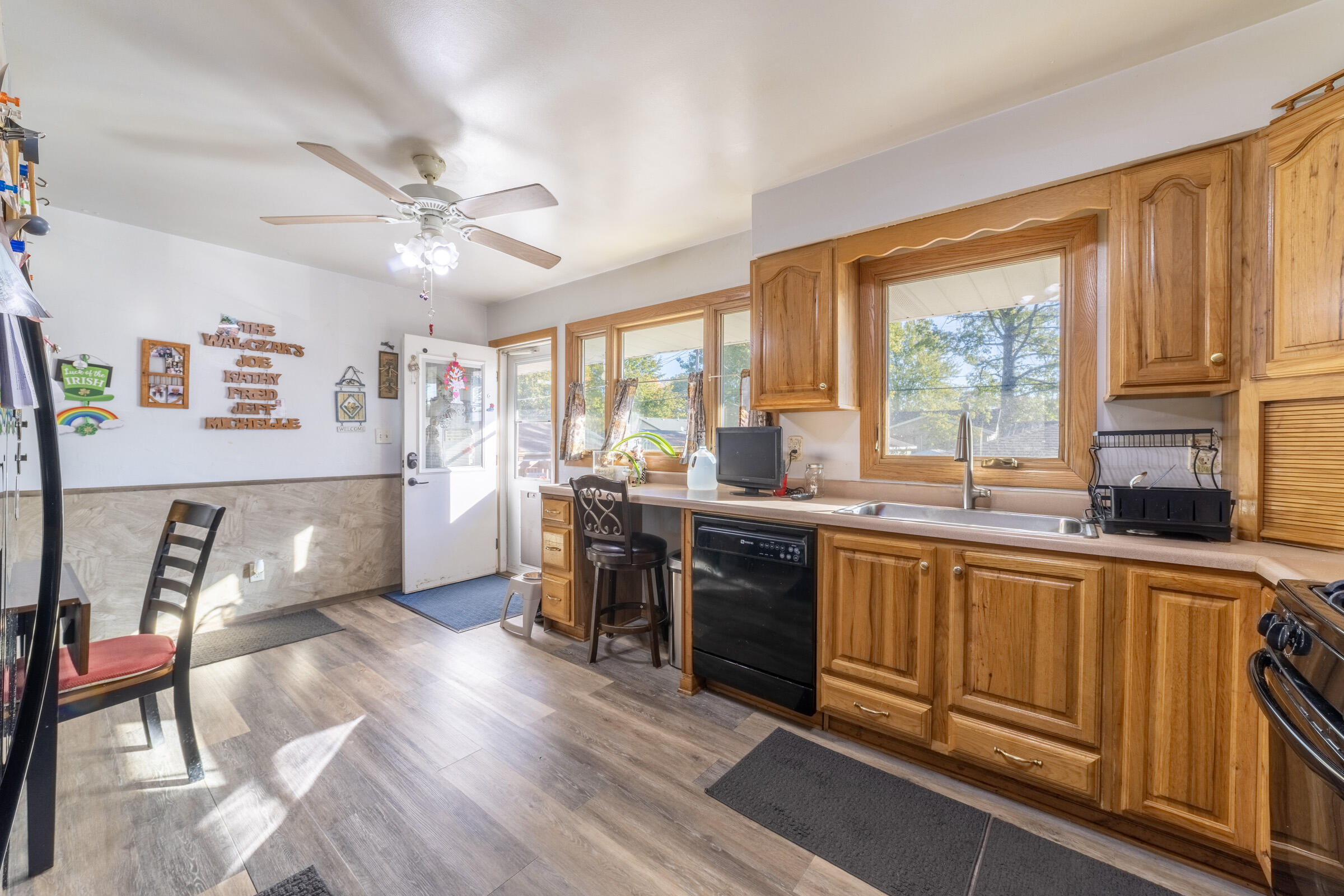 225 North Dwiggins Street Griffith, IN 46319 - Photo 15 of 36 a open kitchen with stainless steel appliances granite countertop a refrigerator a sink dishwasher a stove and white countertops with wooden floor