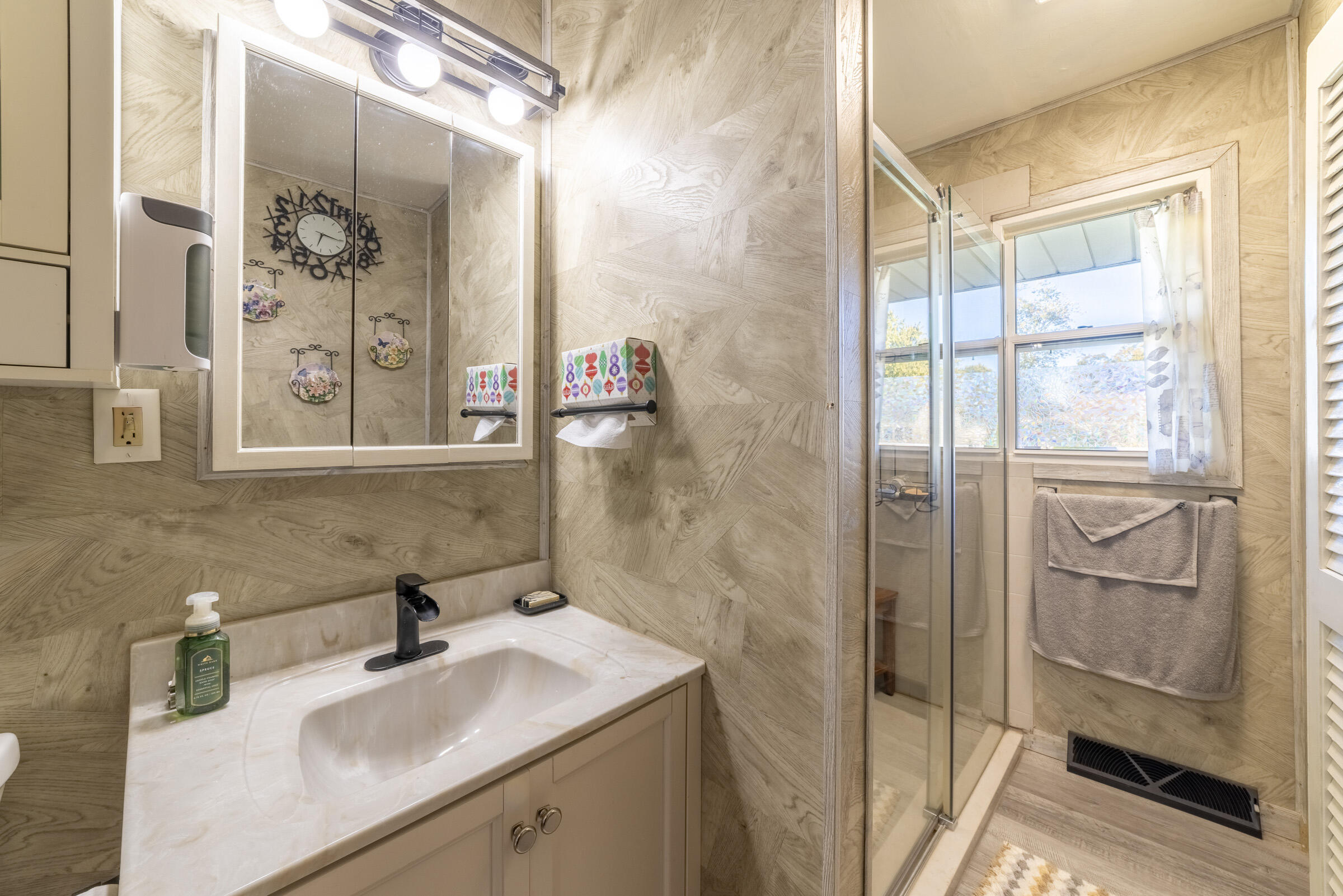 225 North Dwiggins Street Griffith, IN 46319 - Photo 20 of 36 a bathroom with a sink and mirror with shower