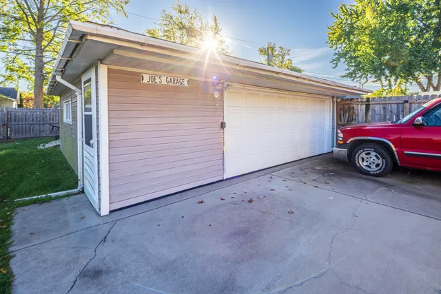 a view of a house with a backyard and a patio