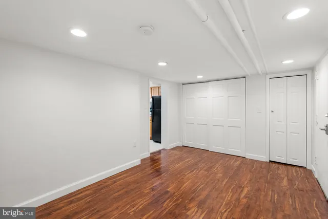 a view of a room with wooden floor