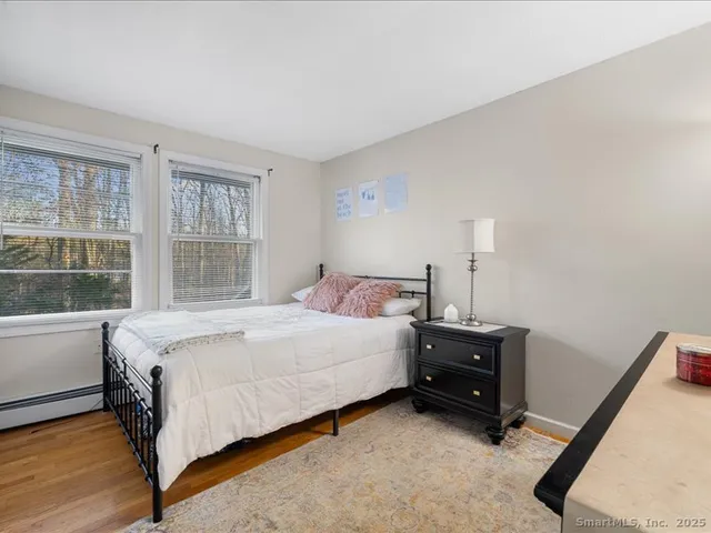 a bed sitting in a bedroom next to a window