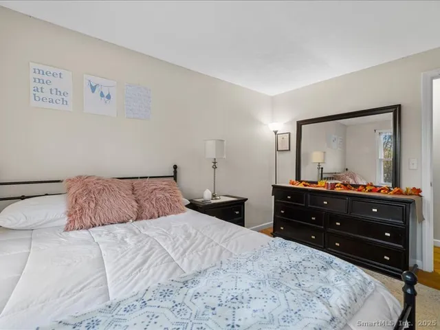 a bedroom with a bed and a mirror