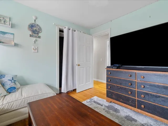 a bedroom with a bed and flat screen tv