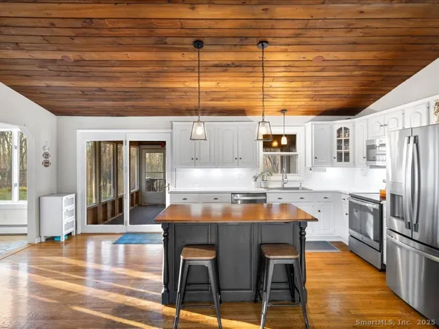 a kitchen with stainless steel appliances granite countertop a sink and cabinets