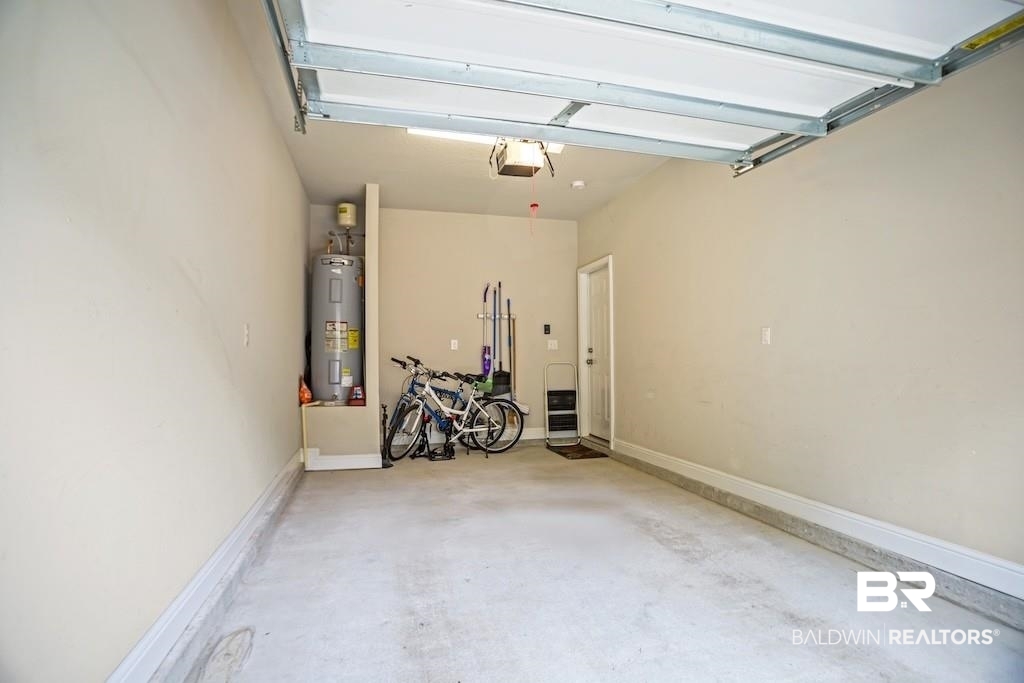 25806 Pollard Road, Unit 27 Daphne, AL 36526 - Photo 42 of 46 Garage featuring water heater and a garage door opener
