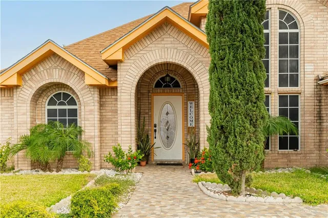 a view of a brick house with potted plants