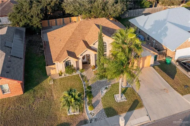 an aerial view of a house with garden space and trees