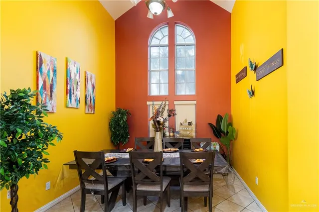 a view of a dining room with furniture and chandelier