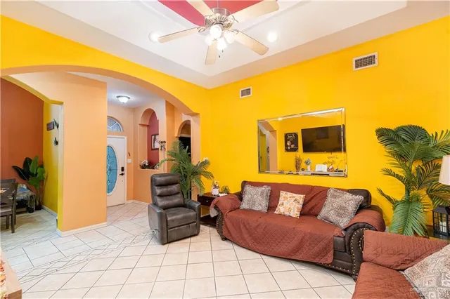 a living room with furniture and kitchen view