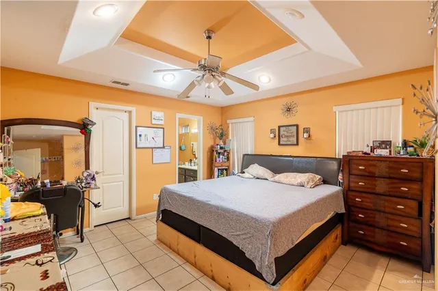 a bedroom with a bed and dresser with mirror