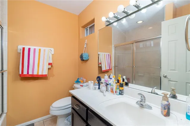 a bathroom with a sink vanity mirror and toilet
