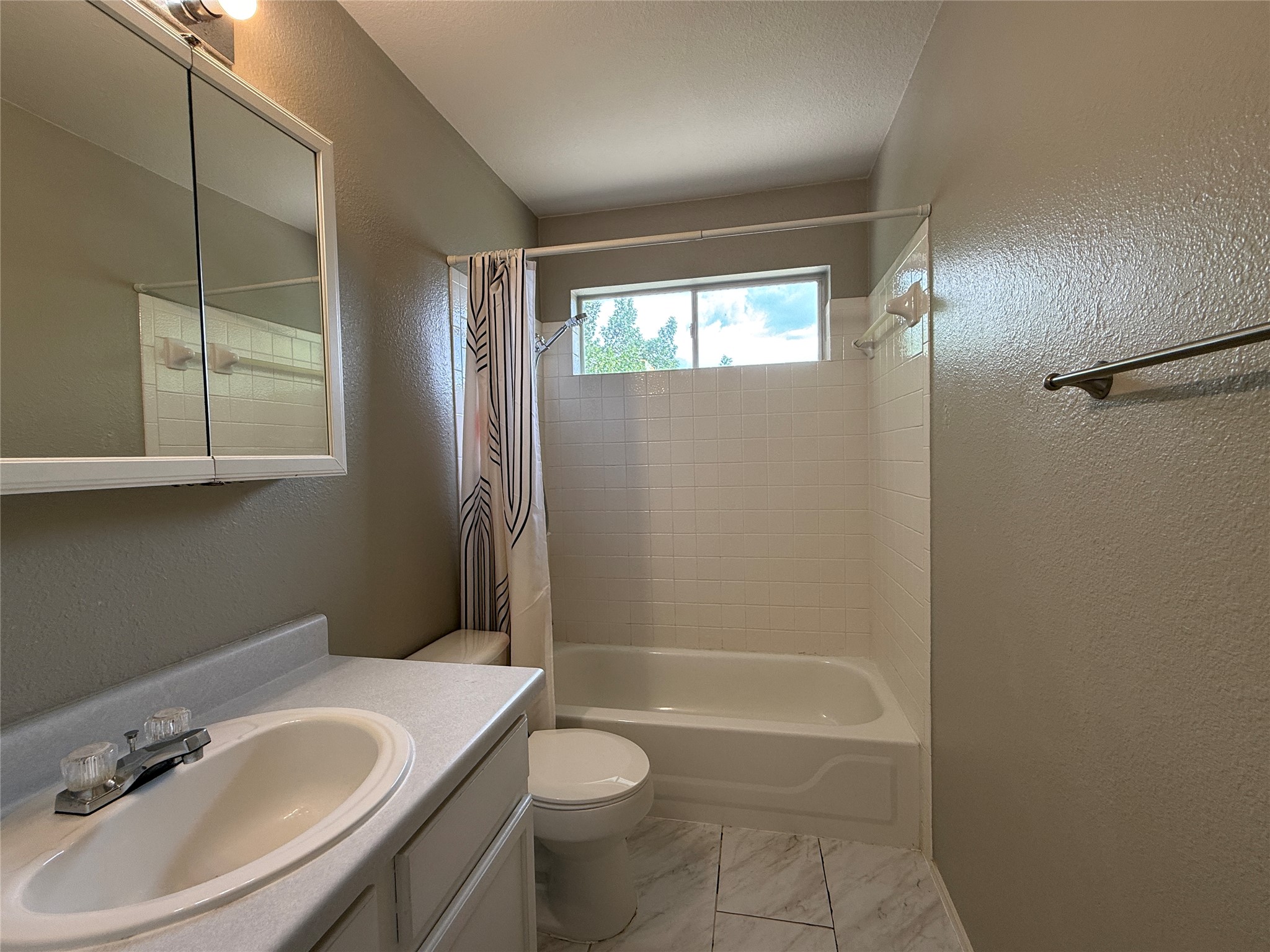 2120 Jester Farms Road Round Rock, TX 78664 - Photo 21 of 28 Functional bathroom features a standard bathtub with an integrated shower, complemented by a simple vanity.