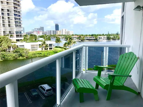 a balcony with table and chairs