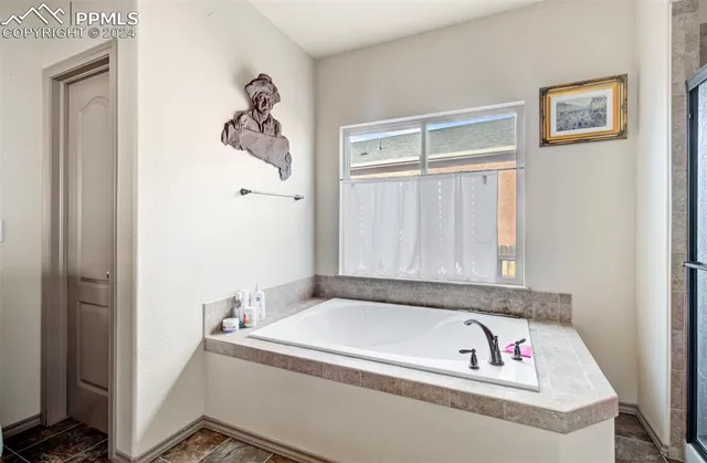a bathroom with a tub and a window
