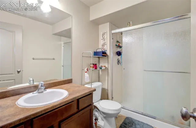 a bathroom with a sink toilet a mirror and shower