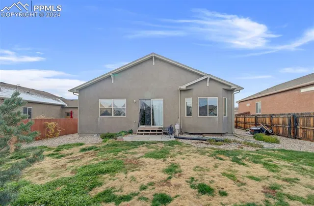 a view of a house with yard and sitting area