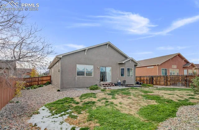 a front view of house with yard and trees around