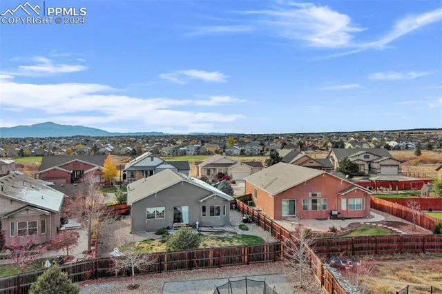 an aerial view of residential houses with city view