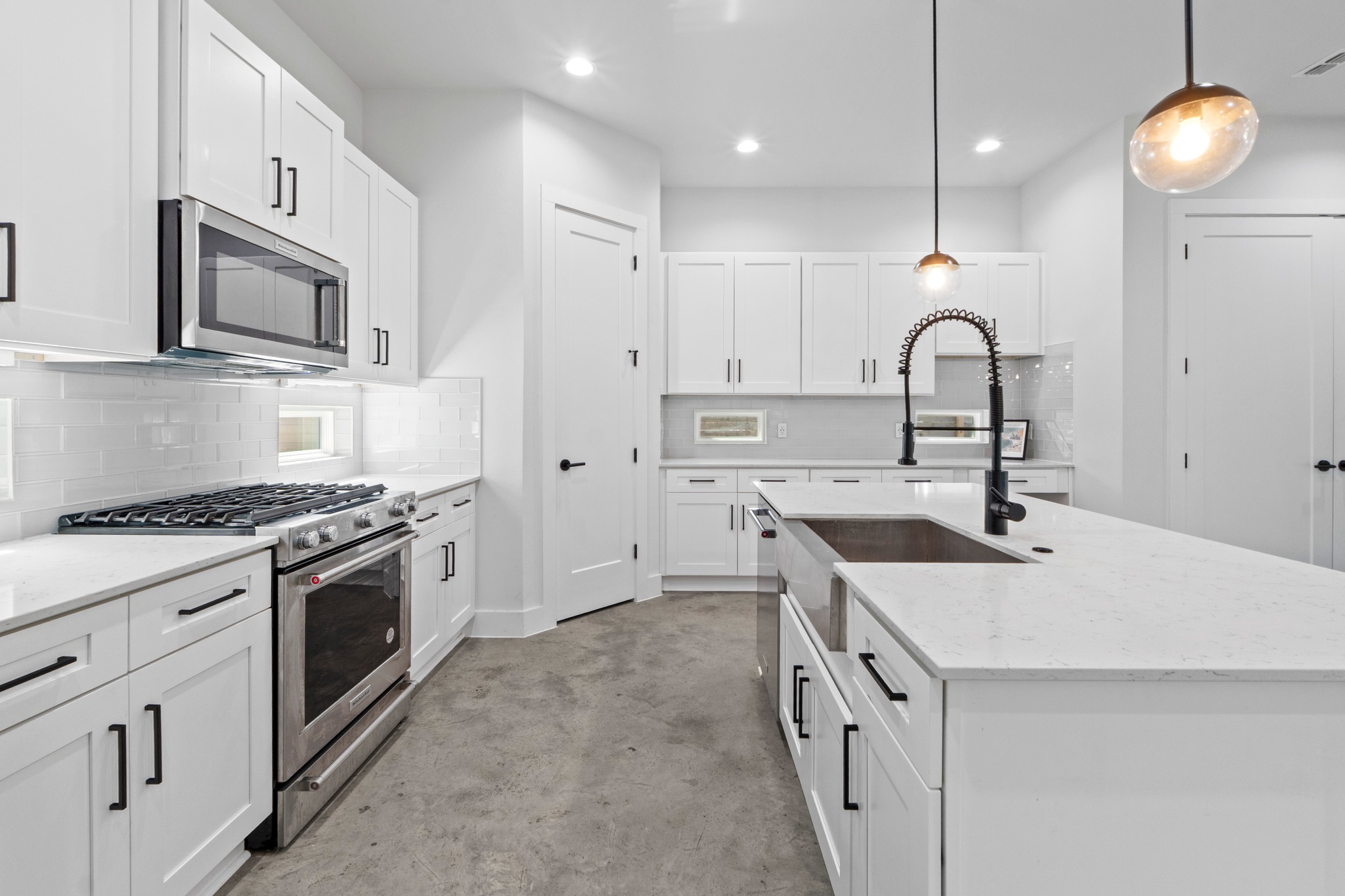 2007 Chestnut Avenue, Unit 1 Austin, TX 78722 - Photo 14 of 32 A well-lit culinary space featuring an expansive island and gleaming stainless steel appliances.