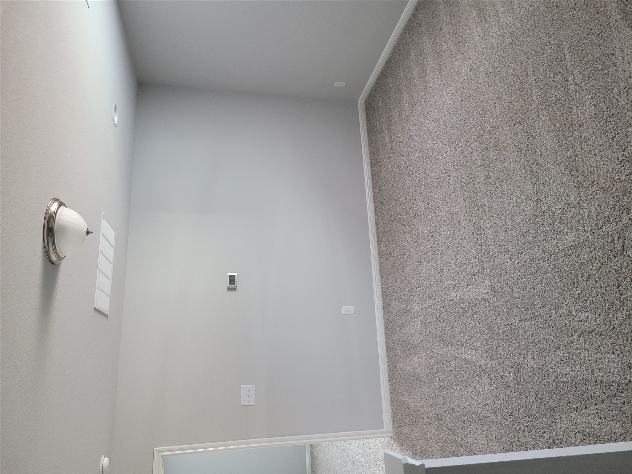 131 Wild Wind Cove Jarrell, TX 76537 - Photo 15 of 26 Neutral-toned carpeted interior space featuring light gray walls, white baseboards, and a semi-flush mount ceiling light